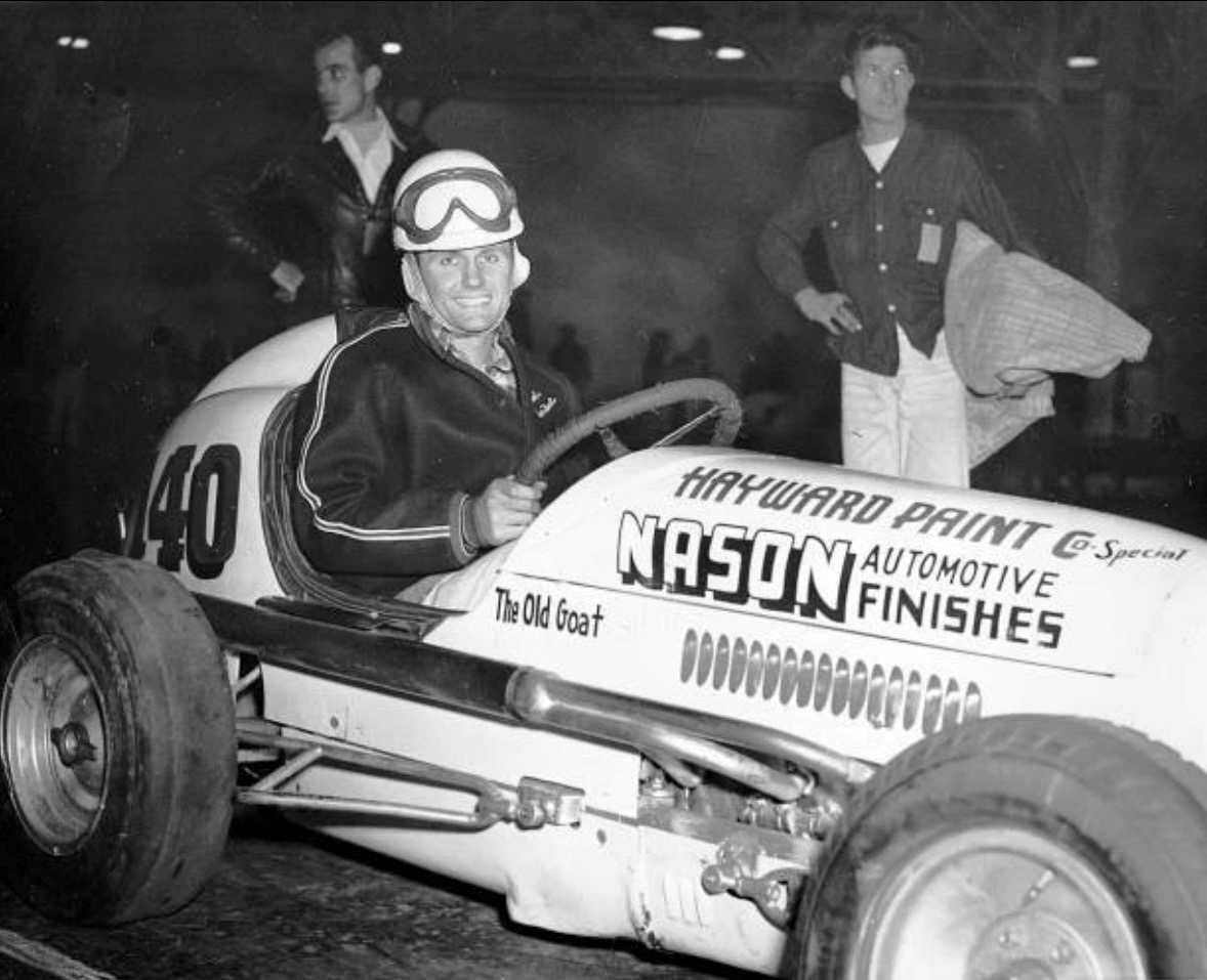 Bob Sweikert sits in his midget car
